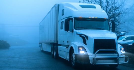 Semi truck in the fog
