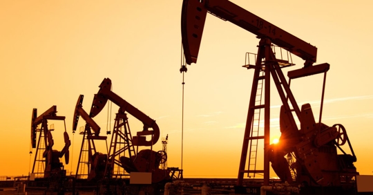 Oil pumps and rig at sunset